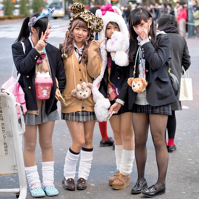 Tokyo Fashion Fun Japanese girls in school uniforms, loose socks, and animal hats on the stree