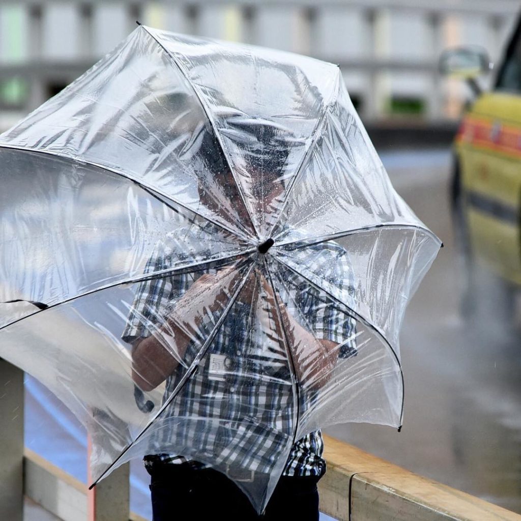 @The Japan Times: A man in Tokyo’s Minato Ward tries to shield himself with an umbrella today as …