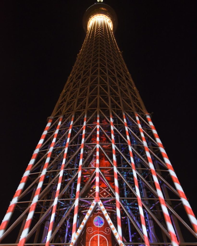 @The Japan Times: A candy cane pattern is projected on the lower section of the Tokyo Skytree in T…
