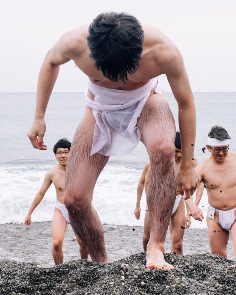 @The Japan Times: After men form a circle on the beach for the Oto Matsuri, a priest joins them to…