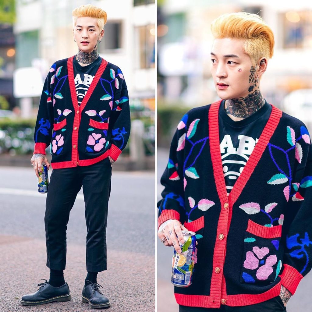 Seho - an artist - on the street in Harajuku wearing a floral knit cardigan over...
