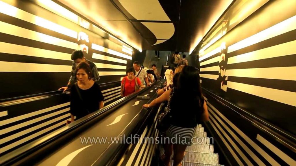 Singapore nationals descend escalator to MRT city underground Singapore nationals descend escalator to MRT city underground