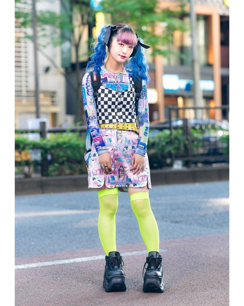 Hiyoko on the street in Harajuku wearing a checkered crop top over a graphic Spi...