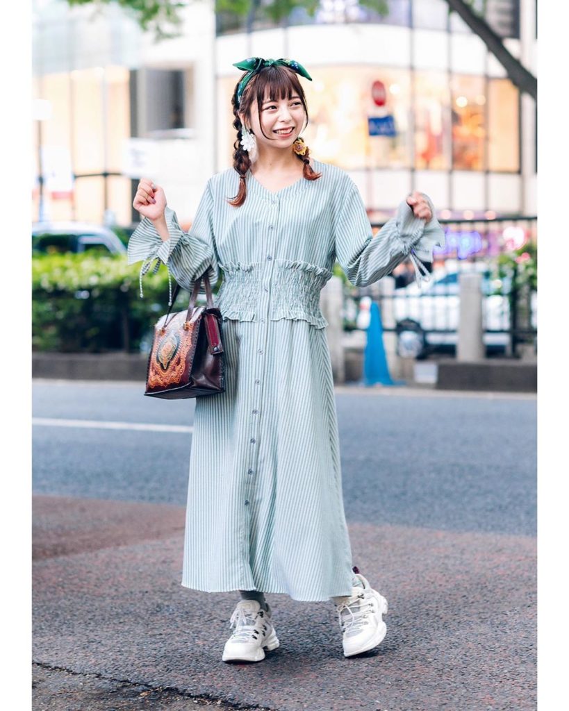 Horie on the street in Harajuku wearing a vintage inspired look featuring a stri...