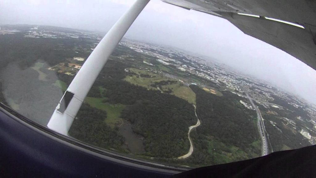 Flying over Okinawa, with EJ Garcia (USMC) piloting a USAF Cessna.