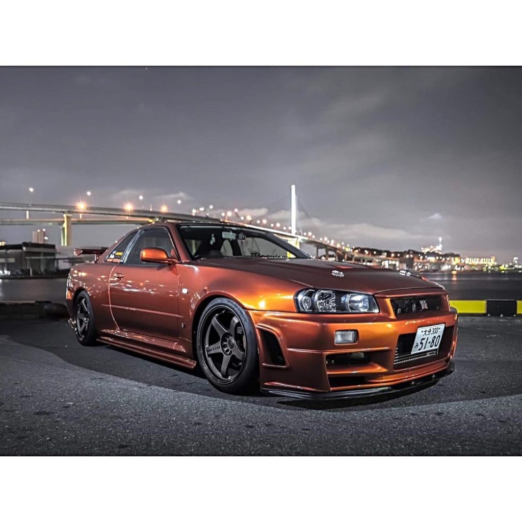 Who loves the R34 in orange then?  Photo  @lowlife_car_photography .
.
.
.
Follo...