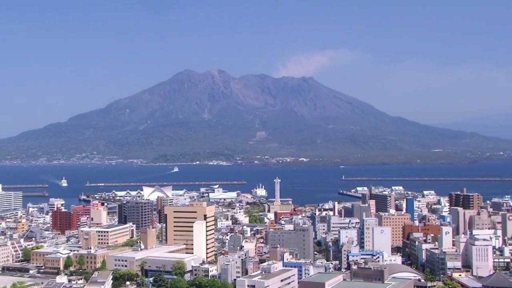 Aerial view of Kagoshima city and Sakurajima active volcano. Timelapse