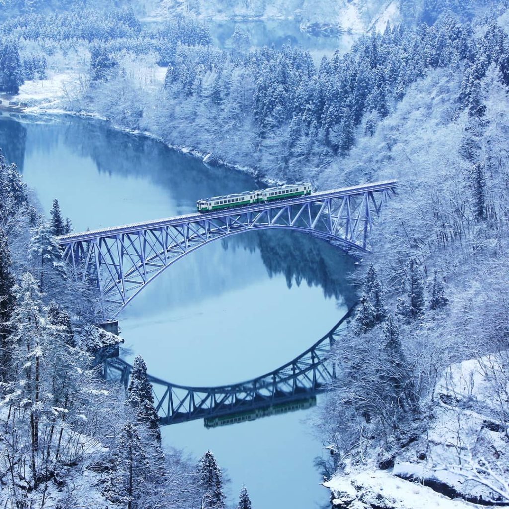 What an incredible capture of the scenic JR Tadami Line train passing through Fu...