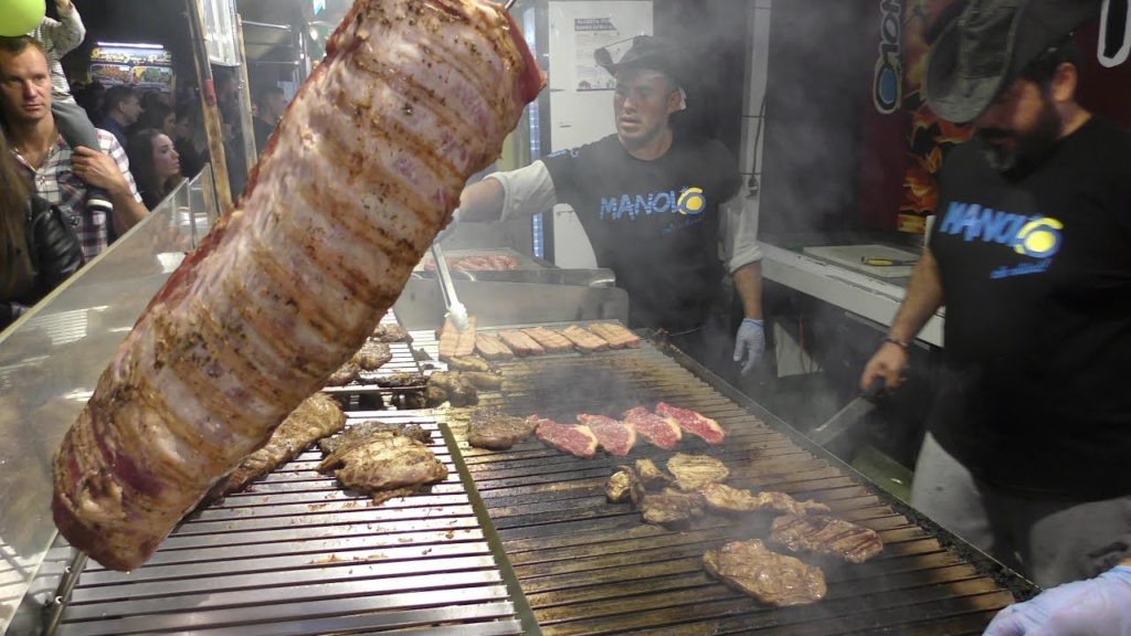 Huge Grill of Beef and Sausages from Argentina. Italy Street Food Festival