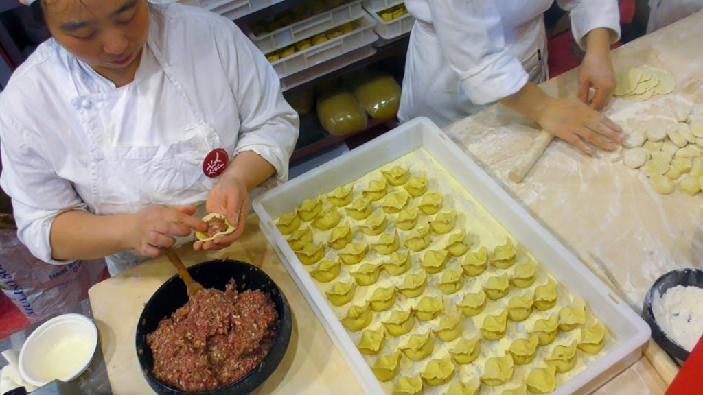 Great Skills Making Chinese Dumplings and Rolls. Street Food Festival seen in Italy