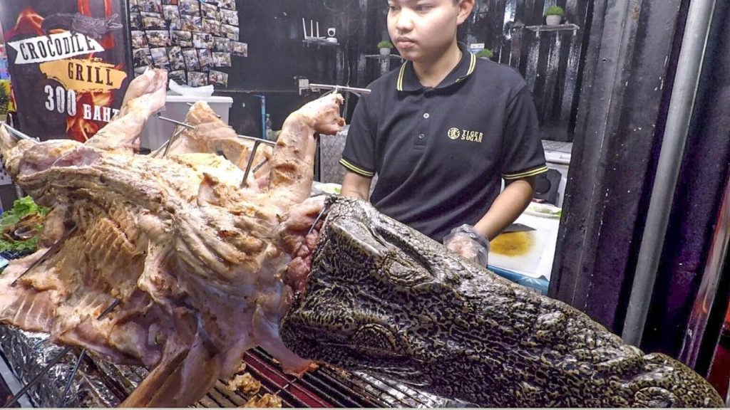 Whole Crocodile Cut and Grilled. Thai Exotic BBQ. Street Food in Phuket, Thailand