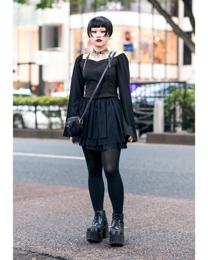 19-year-old Japanese student Hana on the street in Harajuku wearing a dark look ...