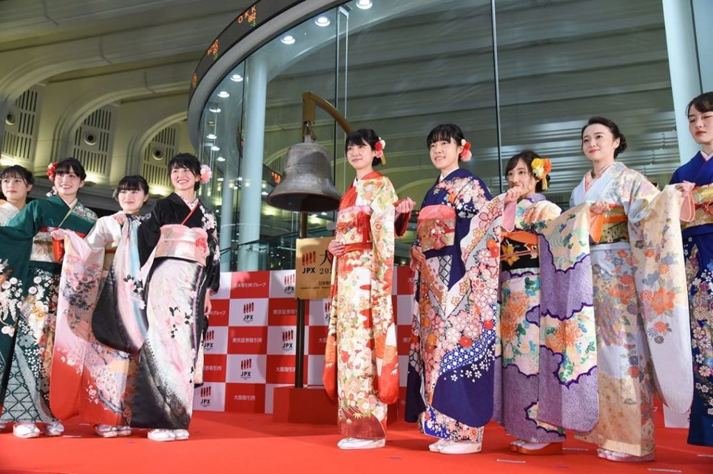 Securities firm employees dressed in kimono pose after Monday's Daihakkai ceremo...