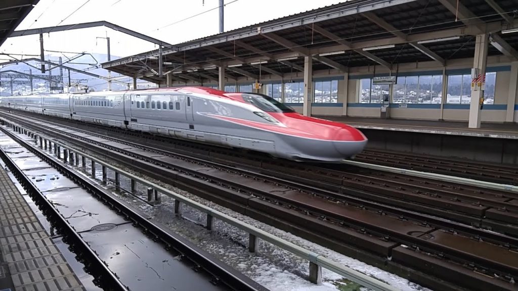 Shinkanksen bullet train speeding through Shiroishi-Zao Station Japan