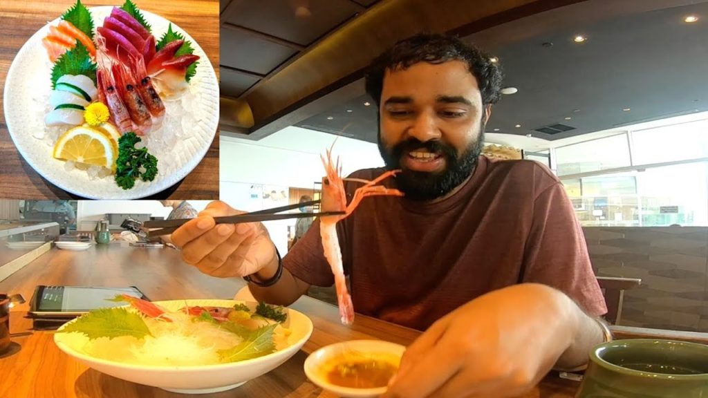 Indian Eating Raw Japanese Seafood in Singapore