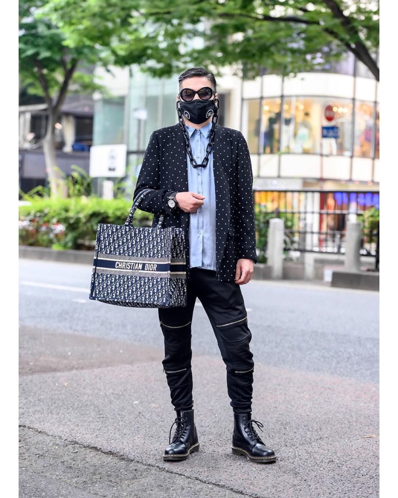 Japanese stylist Tatsuya on the street in Harajuku wearing a Chanel logo face ma...