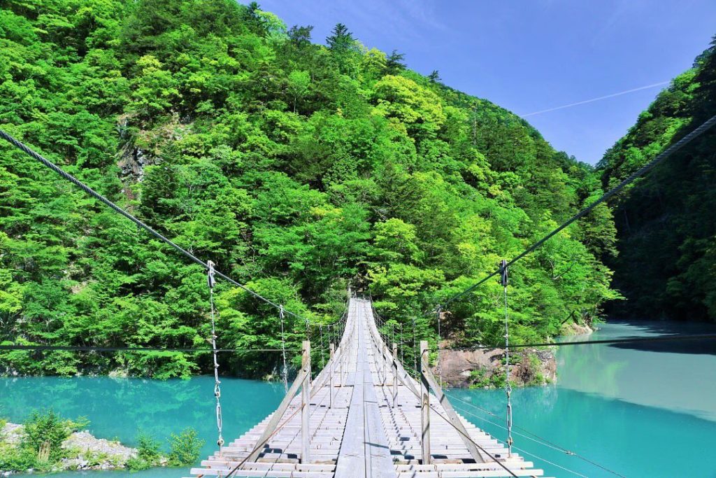 Yume no Tsuribashi is a 295-foot suspension bridge that runs above the emerald g...