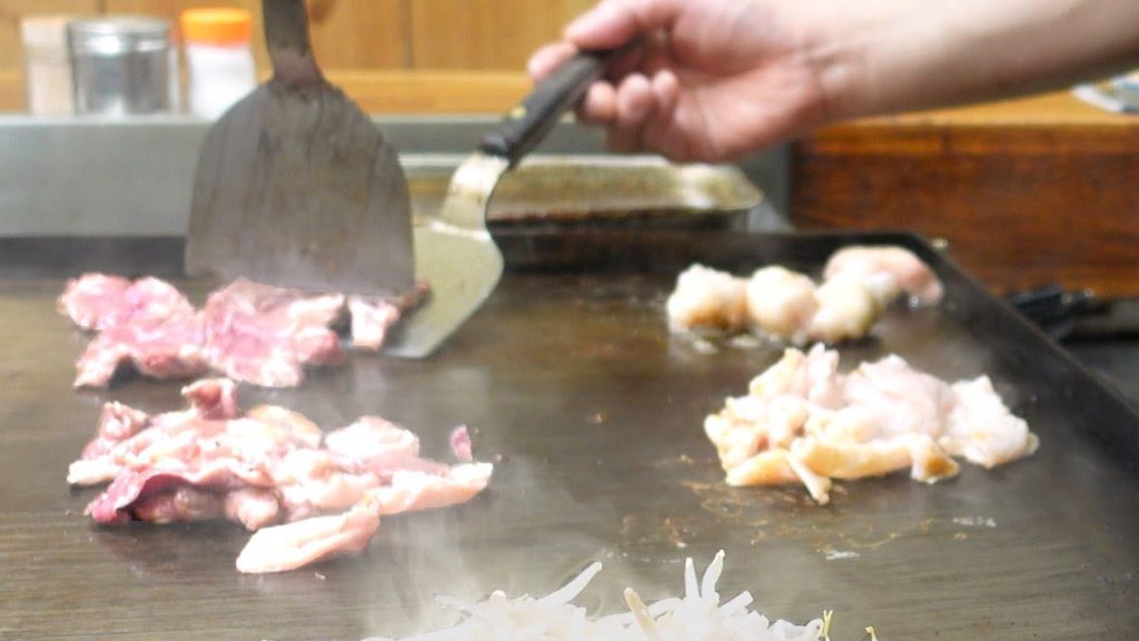 Japanese Street Food - Beef Hormoneyaki TeppanYaki grilled on an iron plate HORMON-DOJO Osaka Japan