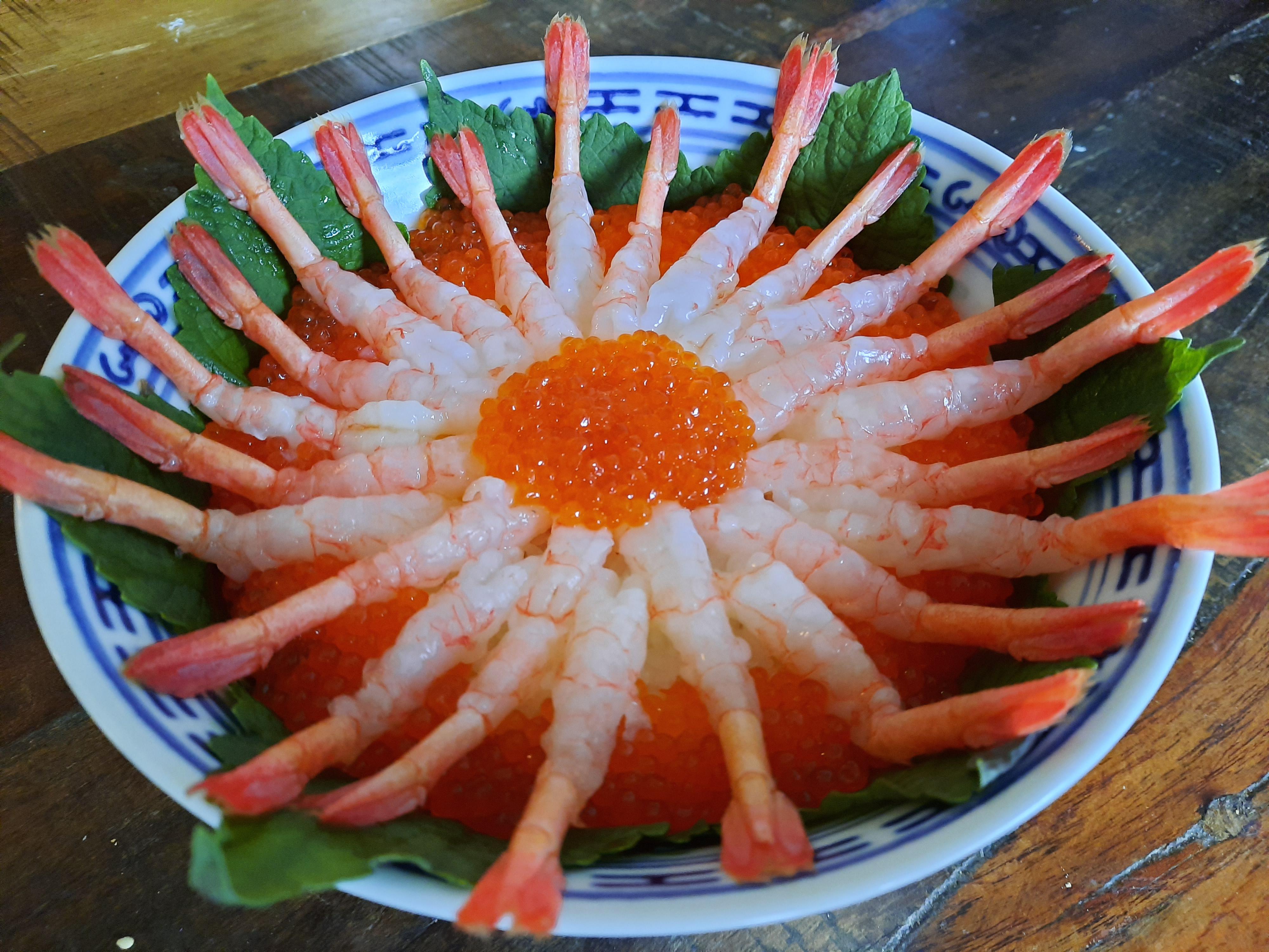 Homemade donburi with spot prawns, ikura, soy marinated egg yolk (under