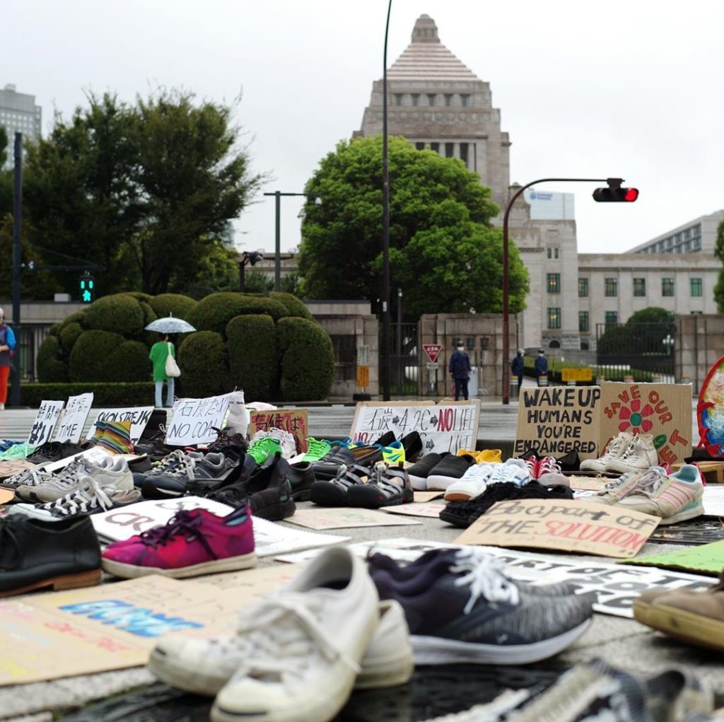 Dozens of pairs of shoes signifying the generations lost to global warming were ...