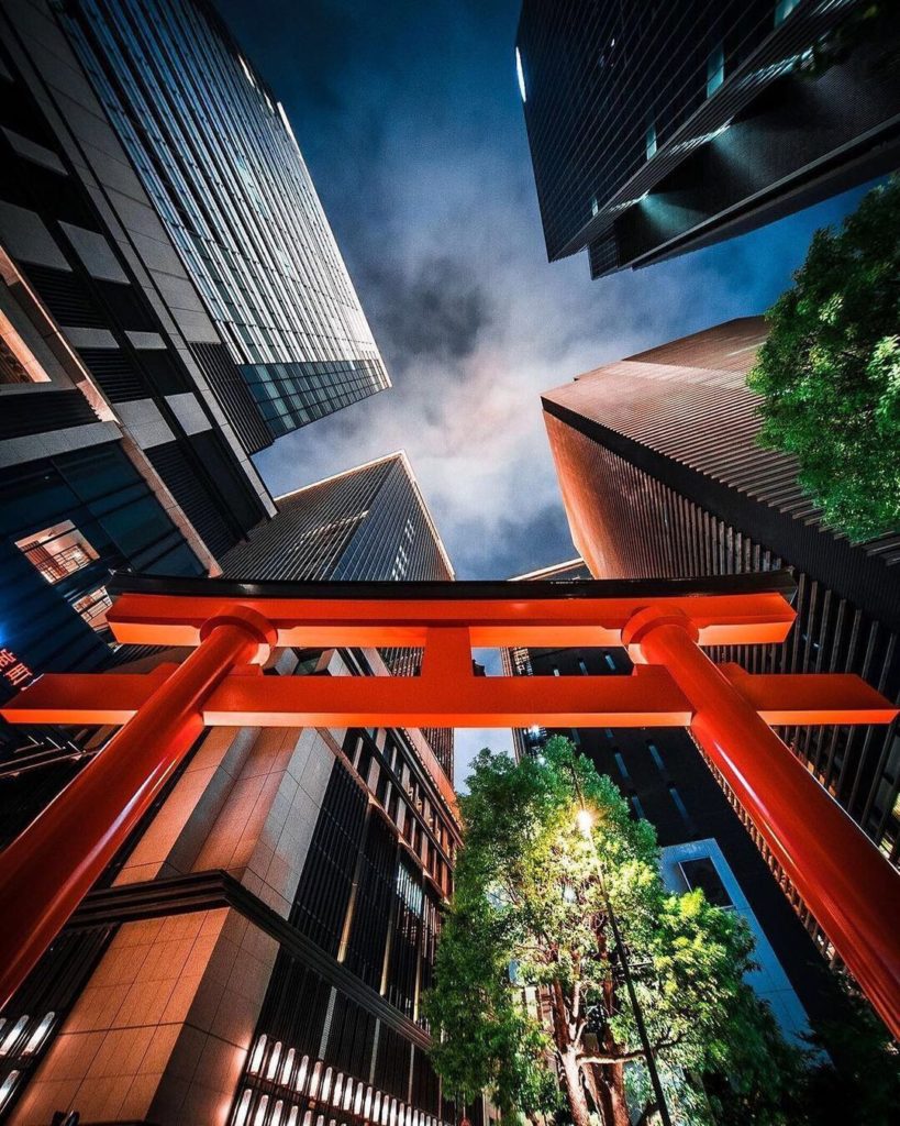 The Fukutoku Shrine in Nihonbashi, Tokyo is surrounded by many modern buildings....