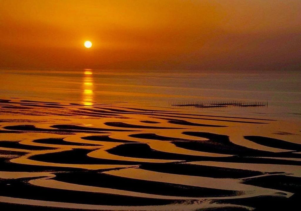 .
Beautiful "waves" in the sand are visible at Okoshiki Beach when the tide is l...