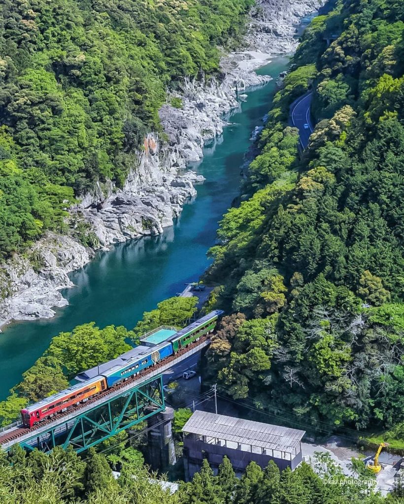 The colorful sightseeing train, SHIKOKU MANNAKA SENNEN MONOGATARI, running throu...