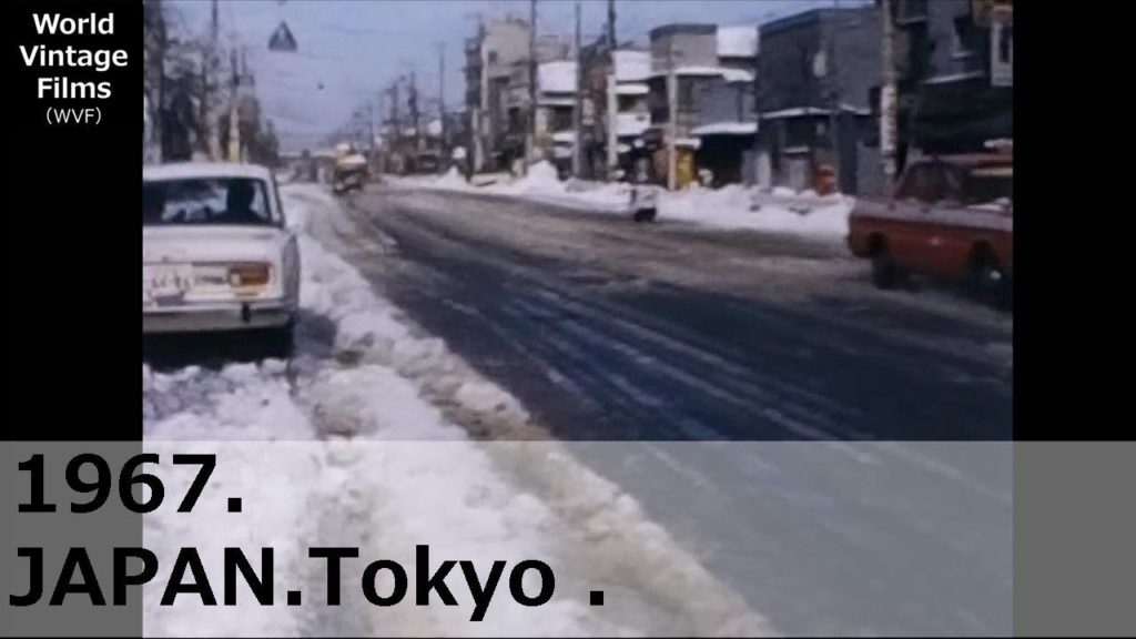 1967.Japan.Tokyo.An image of a rare heavy snowfall. Snow shoveling the next day. Taxi and car pass. 1967.Japan.Tokyo.An image of a rare heavy snowfall. Snow shoveling the next day. Taxi and car pass.
