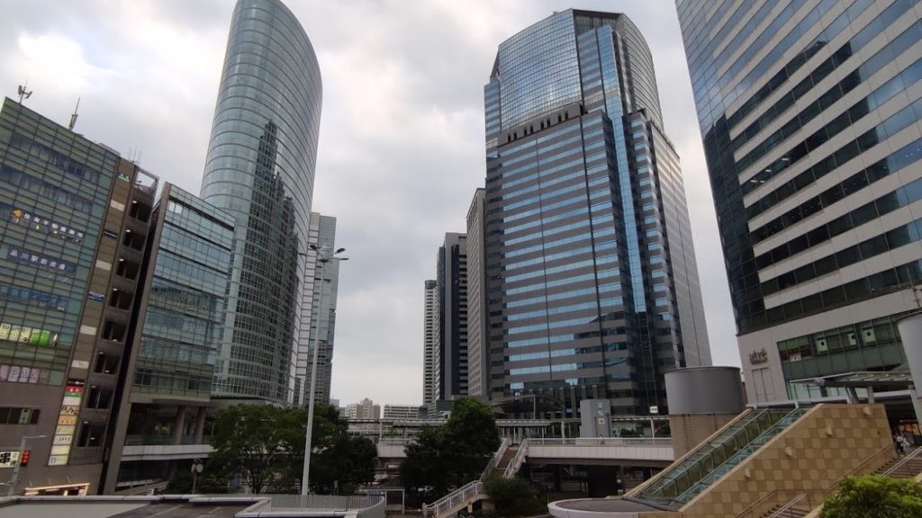 Walking traveler # Japan. Walking tour around the JR station Shinagawa, Tokyo. Cloudy weather.