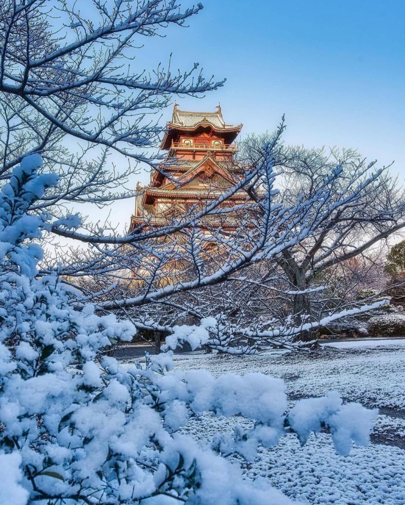 In winter, Fushimi Castle stands amid a world of gleaming white in the rising su...
