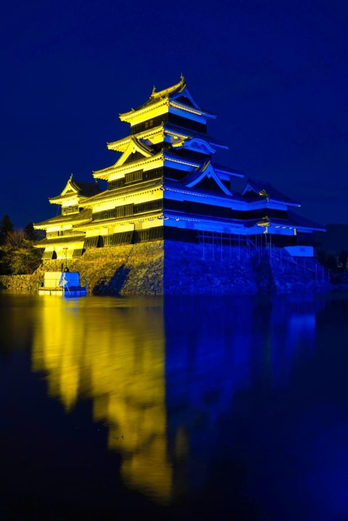 Matsumoto Castle illuminated in blue and yellow