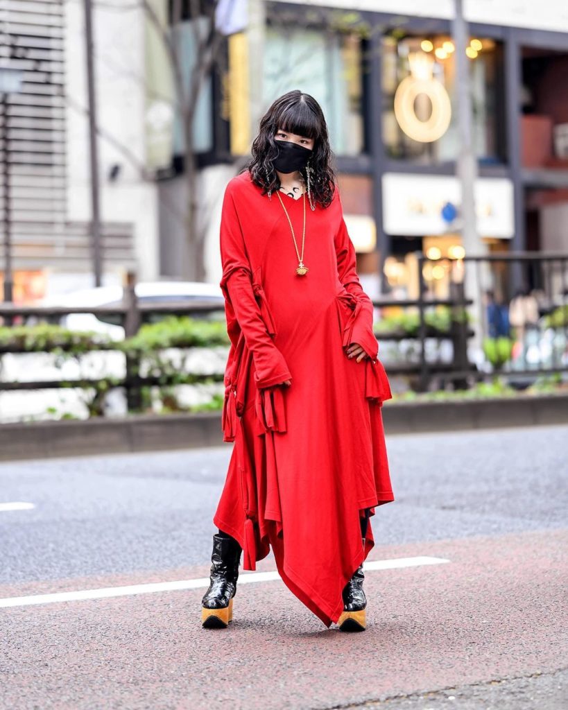 Japanese artist Miyu (@miyurebelrebel) on the street in Harajuku wearing a ribbo...