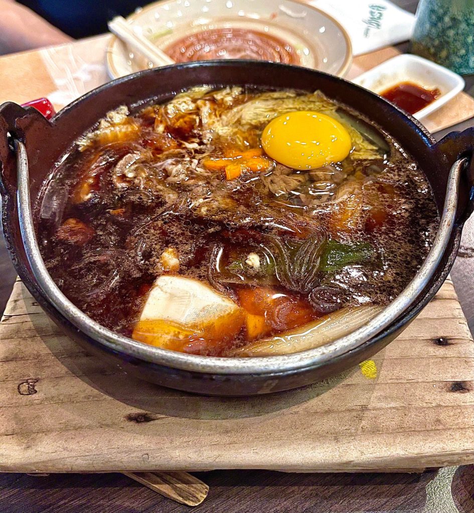 Wagyu sukiyaki in an iron pot