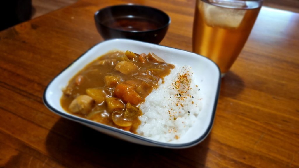 Beautiful Curry Rice I made, with sliced pork chipolatas and a side of miso soup