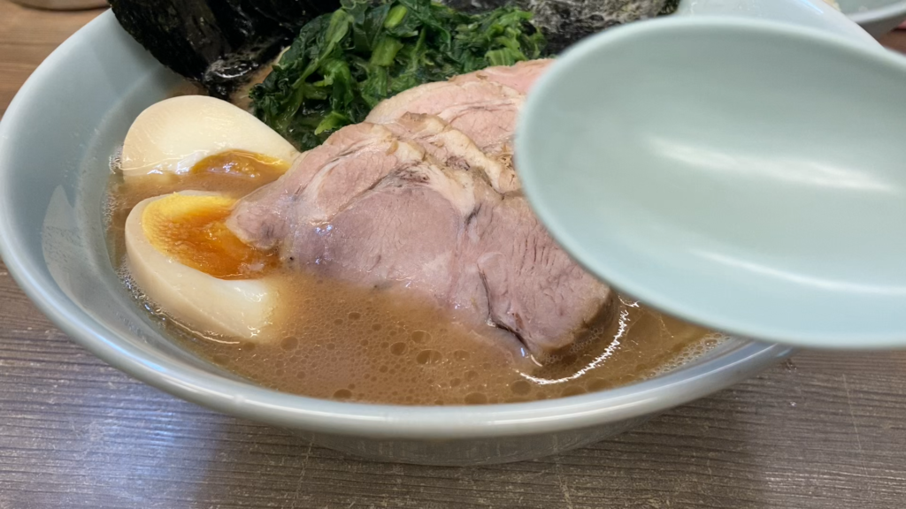 Rich tonkotsu-shoyu ramen soup at “Toraibu” in Tokyo