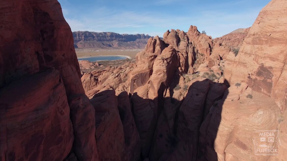 Flying through red rock desert terrain past cliff  in Moab Utah Flying through red rock desert terrain past cliff  in Moab Utah