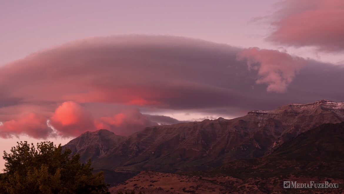 Lenticular clouds during colorful sunset over Timpanogos Mountain