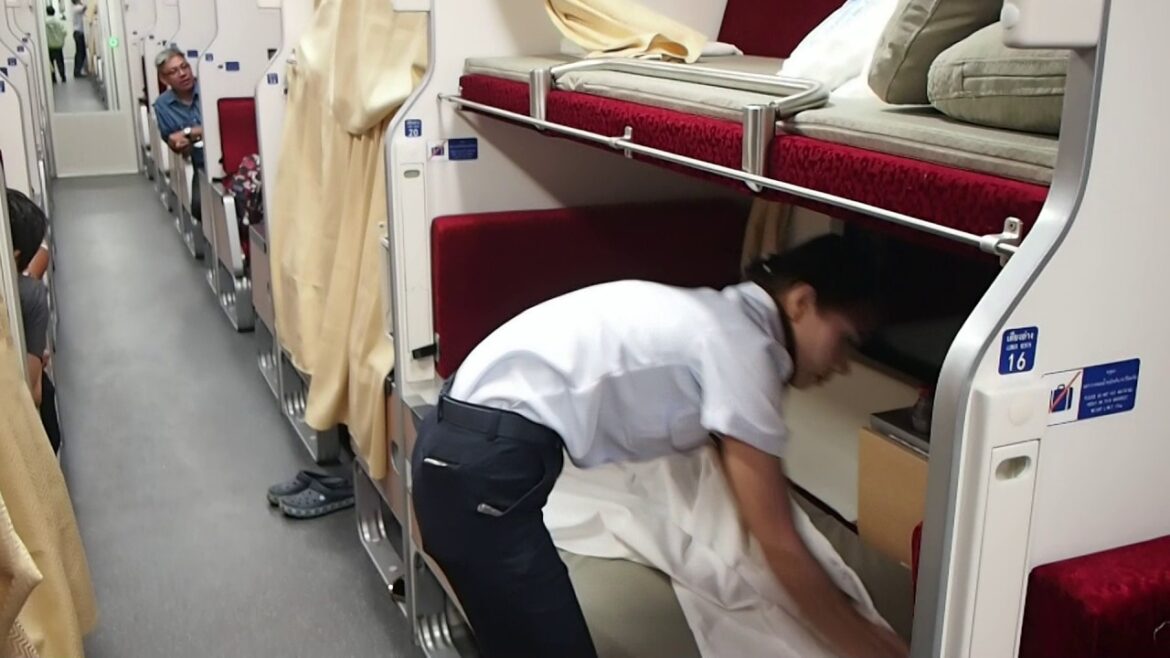 Converting seats into a bed on a Thailand sleeper train
