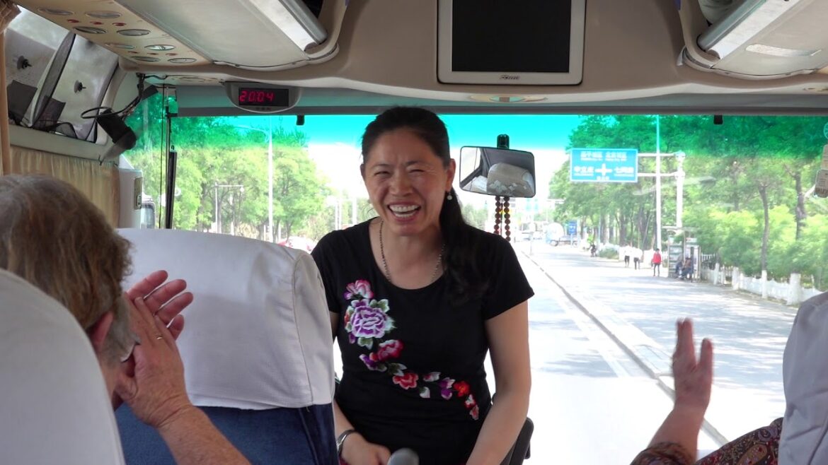 Chinese tour guide Eva singing and talking on the bus in Beijing. Very good!