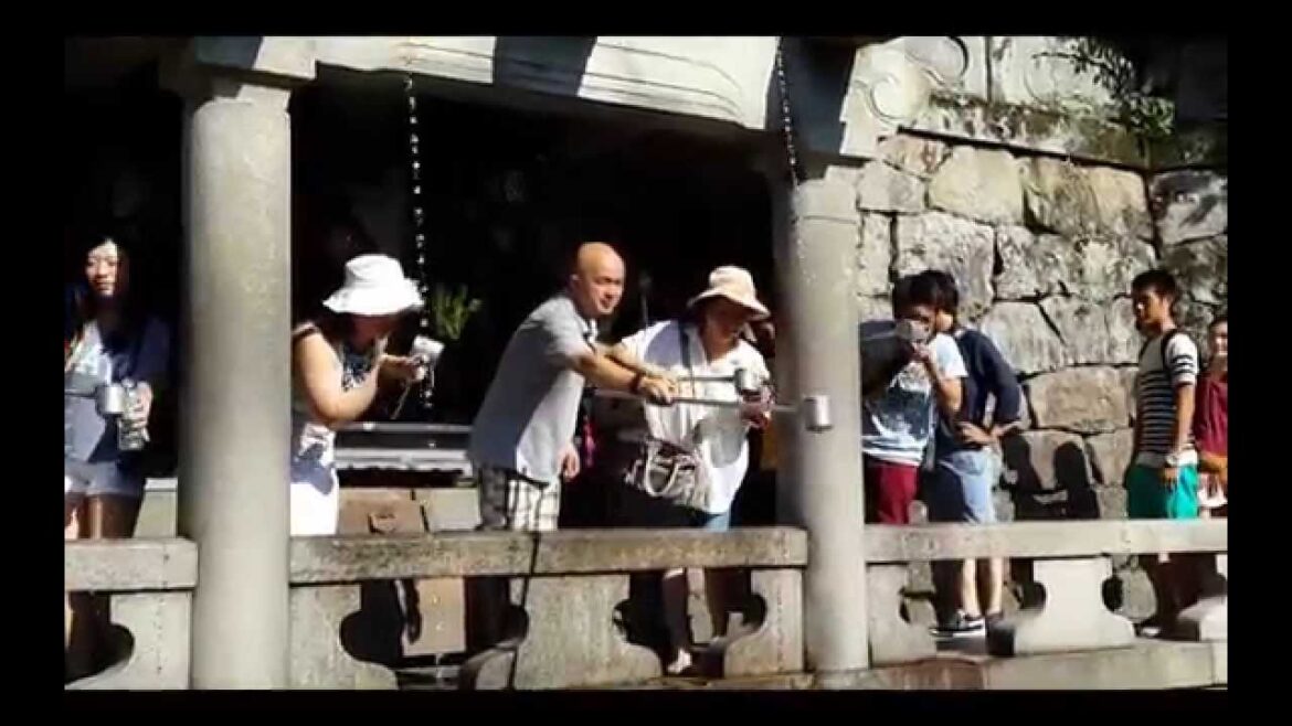 Drinking the Holy Water from Otowa Waterfall at Kiyomizudera Temple in Kyoto, Japan
