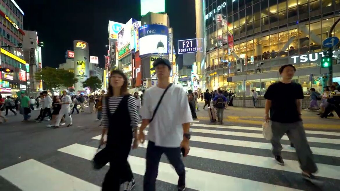 tokyo japan people cross the famous intersection in shibuya tokyo japan Tokyo Stock Footage