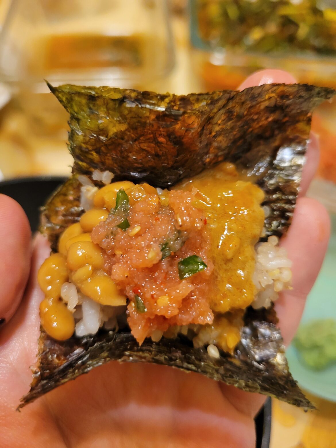 Natto, mentaiko, and crab guts in a seaweed roll