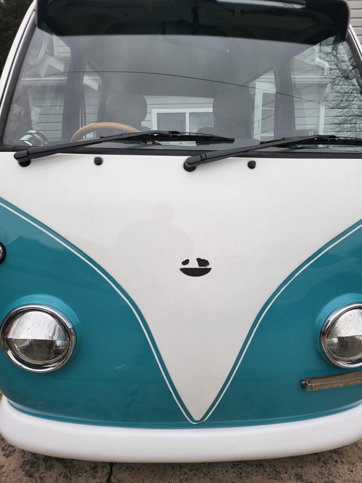 Pulled the subaru badge off the sambar to put the vw badge back on and it left a smiley face