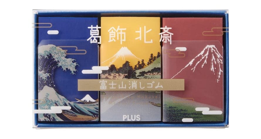 a series of three erasers in blue, yellow, and red., in a box, inspired by Hokusai's renderings of Mt. Fuji