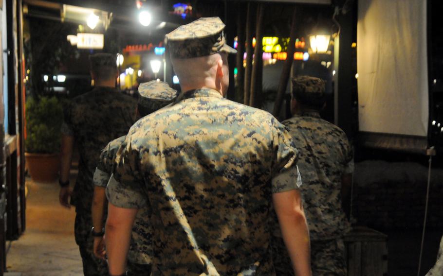 U.S. Marines patrol American Village bars in Chatan, Okinawa, Aug. 2, 2024.