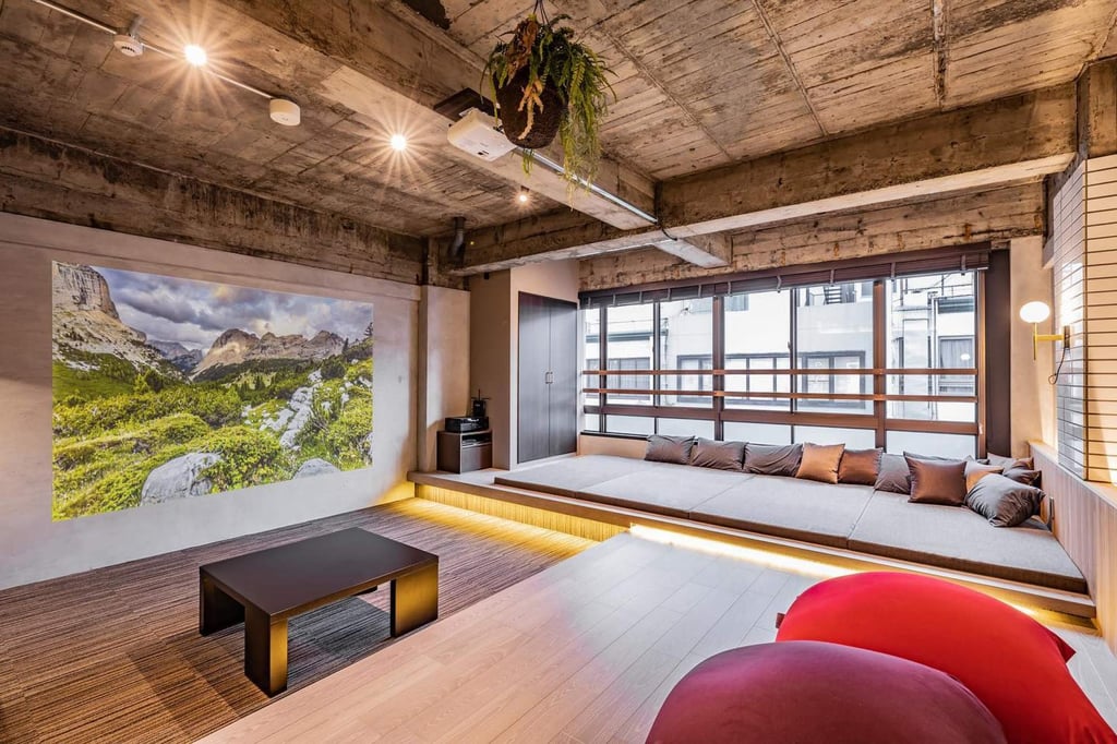 The lounge area of a vacant commercial space converted into guest accommodation. Some rooms have cushions made from Enshu textiles traditionally woven in western Shizuoka prefecture. Photo: Instagram/birupaku_shizuoka