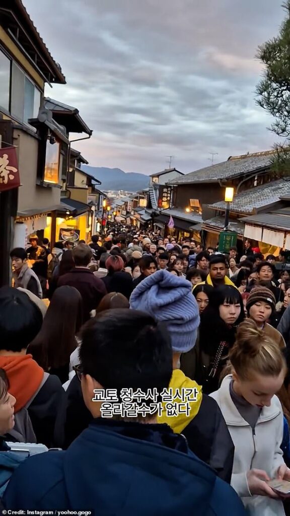 Shocking footage shows hordes of tourists lining an iconic street in Kyoto - sparking concerns the iconic Japanese destination is being overrun by visitors