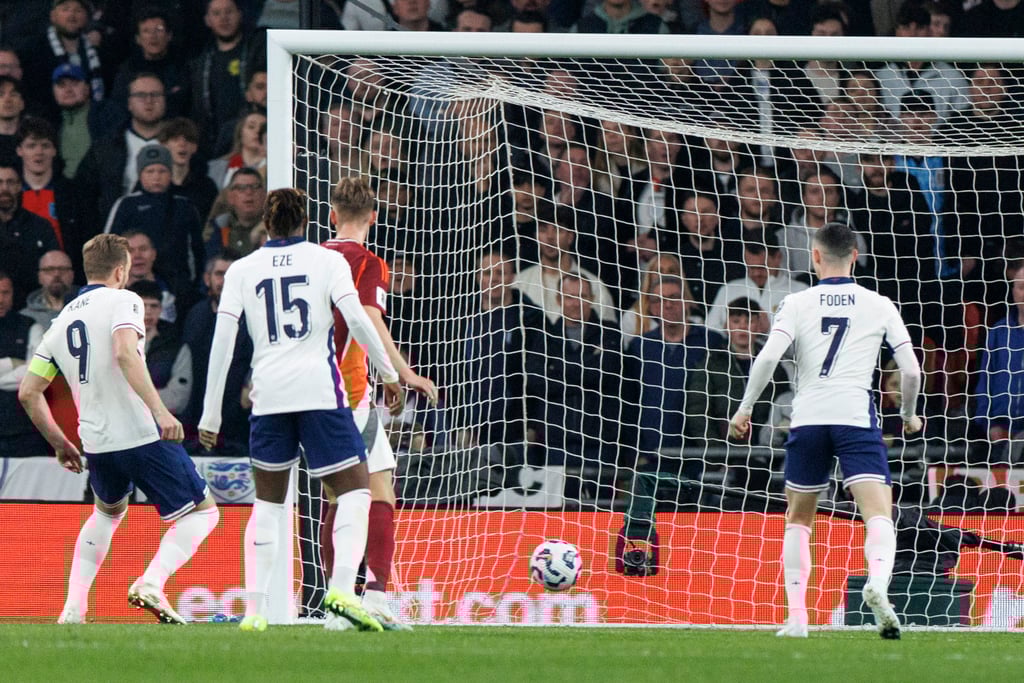 Harry Kane scores England’s second in their 3-0 win over Latvia. Photo: EPA