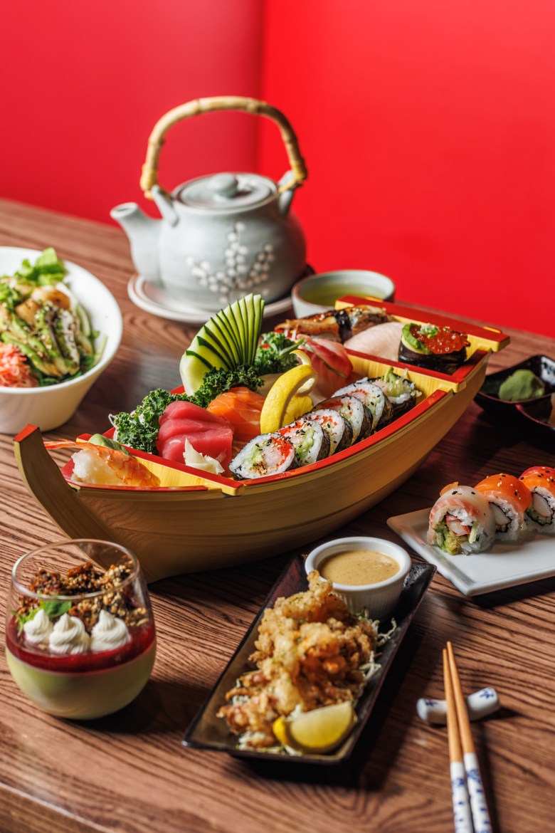 A spread of Mt. Fuji's offerings including geso karaage, matcha-cotta dessert, rainbow rolls, an assortment of nigiri and sashimi.
