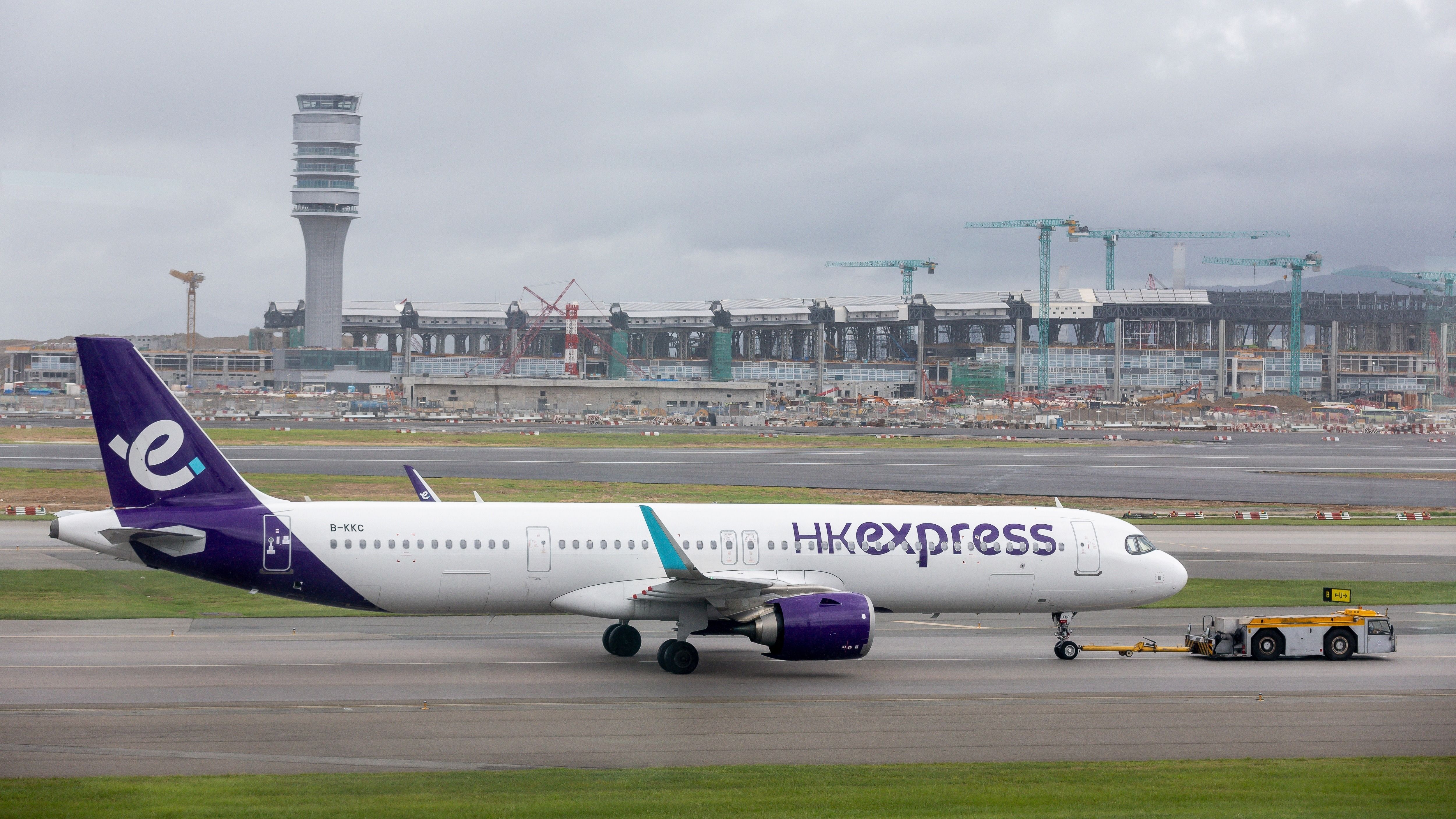 HK Express Airbus A321neo being towed at HKG shutterstock_2507400615